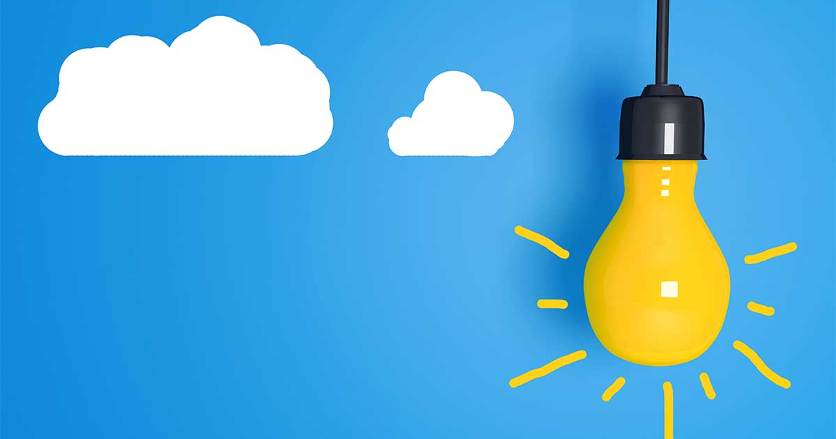 Yellow lightbulb against a cartoon blue sky with clouds